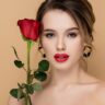 date night beauty tips: charming woman with red lips and fresh rose